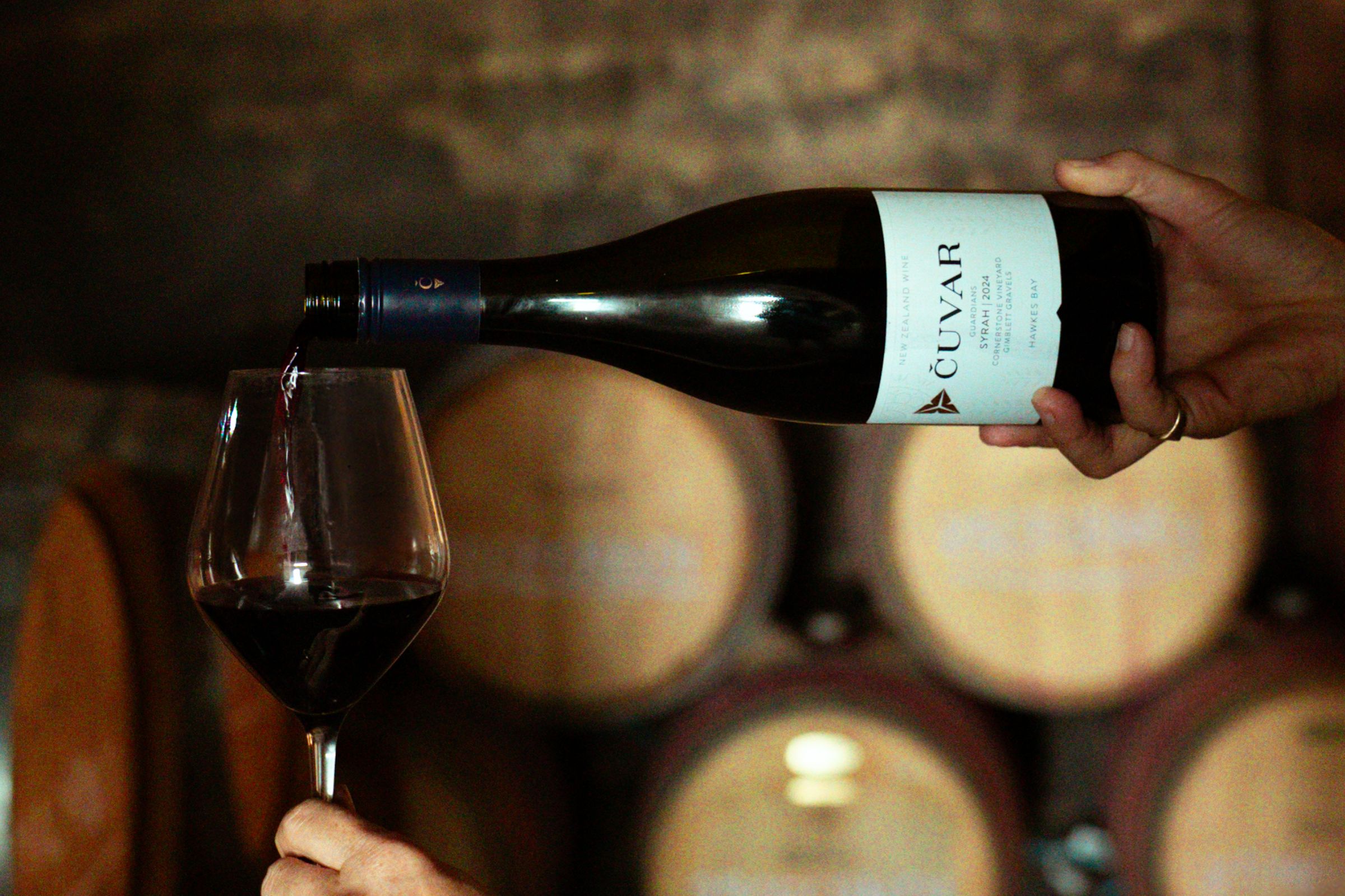 Cuvar Guardians Syrah and Chardonnay 2024 sitting on a barrel